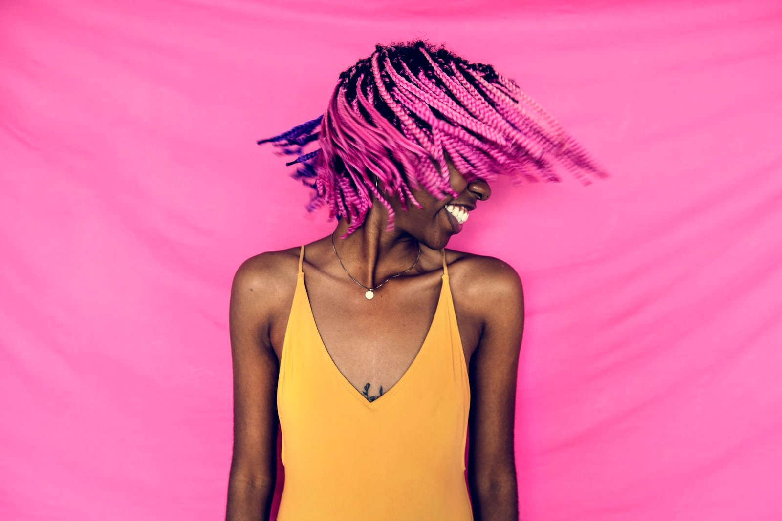 Girl shaking her pink braided hair
